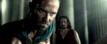 Movie still from “300: Rise of an Empire” (2014), directed by Noam Murro – A man with a beard is looking at the camera; Close Up shot, Over the shoulder angle