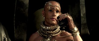 Movie still from “300: Rise of an Empire” (2014), directed by Noam Murro – A man in chains talking on a cell phone; Close Up shot, Low angle