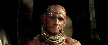 Movie still from “300: Rise of an Empire” (2014), directed by Noam Murro – A bald man wearing a gold necklace and earring; Close Up shot, Low angle