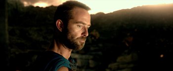 Movie still from “300: Rise of an Empire” (2014), directed by Noam Murro – A person with a beard looking to the side; Close Up shot, Over the shoulder angle