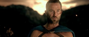 Movie still from “300: Rise of an Empire” (2014), directed by Noam Murro – A man with a beard wearing a blue cape; Close Up shot, Over the shoulder angle