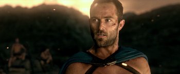 Movie still from “300: Rise of an Empire” (2014), directed by Noam Murro – A person with a beard wearing a cape; Close Up shot, Over the shoulder angle