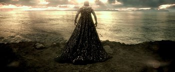 Movie still from “300: Rise of an Empire” (2014), directed by Noam Murro – A woman standing on the beach wearing a dress; Extreme Wide shot, Low angle