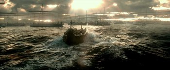 Movie still from “300: Rise of an Empire” (2014), directed by Noam Murro – Several boats in the ocean with a cloudy sky in the background; Extreme Wide shot, High angle