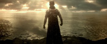 Movie still from “300: Rise of an Empire” (2014), directed by Noam Murro – A man standing on top of a cliff looking out at the ocean; Wide shot, Low angle