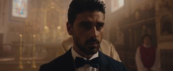 A person wearing a suit and a bow tie