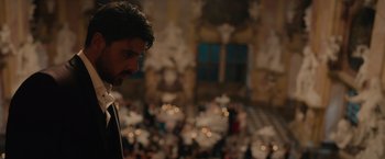 A man standing in front of a crowd of people in a building