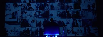 A man sitting in front of a computer monitor