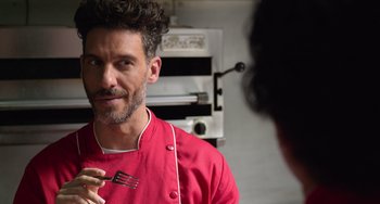 Movie still from “40 Years Young” (2022), directed by Pietro Loprieno – A man in a red shirt is looking at himself in the mirror; Close Up shot, Over the shoulder angle