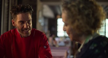 Movie still from “40 Years Young” (2022), directed by Pietro Loprieno – A man and a woman are talking to each other; Close Up shot, Over the shoulder angle