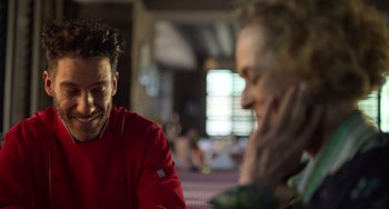 Movie still from “40 Years Young” (2022), directed by Pietro Loprieno – A man and a woman sitting at a table talking to each other; Close Up shot, Over the shoulder angle