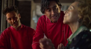 Movie still from “40 Years Young” (2022), directed by Pietro Loprieno – A man in a red jacket talking to another man; Close Up shot, Over the shoulder angle