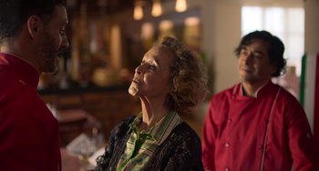 Movie still from “40 Years Young” (2022), directed by Pietro Loprieno – An older woman is sitting in front of a man; Close Up shot, Over the shoulder angle