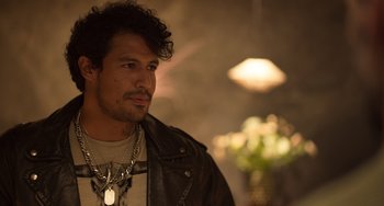 Movie still from “40 Years Young” (2022), directed by Pietro Loprieno – A person wearing a leather jacket; Close Up shot, Over the shoulder angle