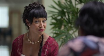 Movie still from “40 Years Young” (2022), directed by Pietro Loprieno – A person wearing a necklace; Close Up shot, Over the shoulder angle