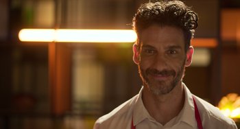 Movie still from “40 Years Young” (2022), directed by Pietro Loprieno – A person smiling for the camera; Close Up shot, Low angle