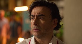 Movie still from “40 Years Young” (2022), directed by Pietro Loprieno – A person wearing a white shirt; Close Up shot, Over the shoulder angle