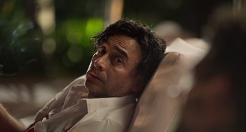 Movie still from “40 Years Young” (2022), directed by Pietro Loprieno – A person laying on a chair; Close Up shot, Over the shoulder angle