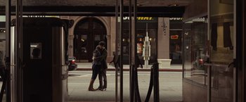 Movie still from “500 Days of Summer” (2009), directed by Marc Webb – A man and a woman kissing on the sidewalk; Wide shot, Over the shoulder angle