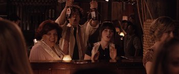 Movie still from “500 Days of Summer” (2009), directed by Marc Webb – A group of people sitting at a bar drinking beer; Medium shot, Over the shoulder angle