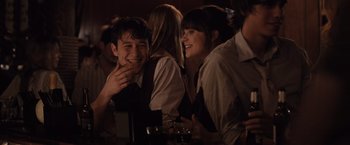 Movie still from “500 Days of Summer” (2009), directed by Marc Webb – A group of people sitting at a table with drinks; Medium shot, Over the shoulder angle