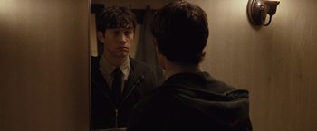 Movie still from “500 Days of Summer” (2009), directed by Marc Webb – A young man looking at himself in the mirror; Close Up shot, Over the shoulder angle