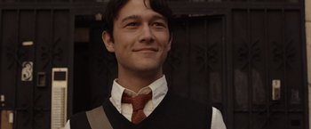 Movie still from “500 Days of Summer” (2009), directed by Marc Webb – A man wearing a vest and a neck tie smiling; Close Up shot, Over the shoulder angle