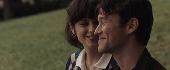 Movie still from “500 Days of Summer” (2009), directed by Marc Webb – A man and a woman smiling at each other in the grass; Close Up shot, Over the shoulder angle