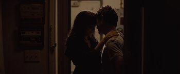 Movie still from “500 Days of Summer” (2009), directed by Marc Webb – A man and a woman are kissing in a dark room; Medium shot, High angle