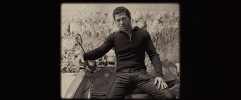 Movie still from “500 Days of Summer” (2009), directed by Marc Webb – A man sitting on the back of a motor scooter; Medium shot, High angle