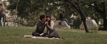 Movie still from “500 Days of Summer” (2009), directed by Marc Webb – A man and a woman sitting on a blanket in the grass; Wide shot, High angle