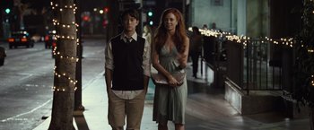 Movie still from “500 Days of Summer” (2009), directed by Marc Webb – A man and a woman standing next to each other on a sidewalk; Medium shot, Over the shoulder angle