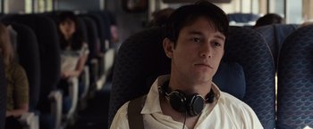 Movie still from “500 Days of Summer” (2009), directed by Marc Webb – A man with headphones sitting in a chair; Close Up shot, High angle