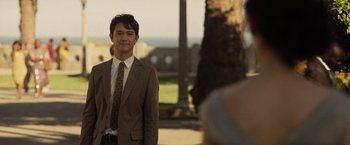 Movie still from “500 Days of Summer” (2009), directed by Marc Webb – A man in a suit and tie standing in front of a tree; Medium shot, Over the shoulder angle