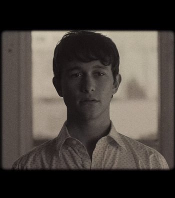 Movie still from “500 Days of Summer” (2009), directed by Marc Webb – A man in a white shirt is looking at the camera; Close Up shot, Low angle