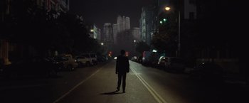 Movie still from “500 Days of Summer” (2009), directed by Marc Webb – A person walking down a street at night; Wide shot, Low angle