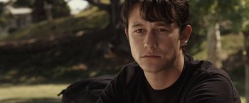 Movie still from “500 Days of Summer” (2009), directed by Marc Webb – A person wearing a black t - shirt; Close Up shot, Over the shoulder angle