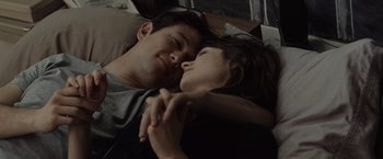 Movie still from “500 Days of Summer” (2009), directed by Marc Webb – A man and a woman laying in bed together; Close Up shot, Overhead angle