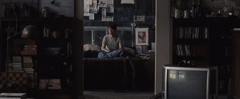 Movie still from “500 Days of Summer” (2009), directed by Marc Webb – A person sitting on a bed in a room; Wide shot, High angle
