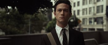 Movie still from “500 Days of Summer” (2009), directed by Marc Webb – A man in a suit and tie standing in front of a building; Close Up shot, Over the shoulder angle