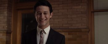 Movie still from “500 Days of Summer” (2009), directed by Marc Webb – A man in a suit and tie smiling for the camera; Close Up shot, Over the shoulder angle