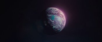 Movie still from “65” (2023), directed by Bryan Woods – An image of an earth with a sun in the background; Extreme Wide shot, Low angle