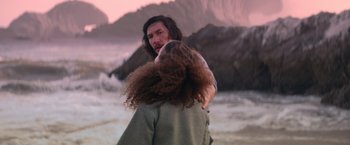 Movie still from “65” (2023), directed by Bryan Woods – A man and a woman standing next to each other on the beach; Medium shot, Over the shoulder angle