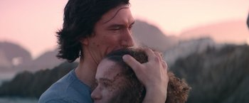 Movie still from “65” (2023), directed by Bryan Woods – A person holding another person's face; Close Up shot, Low angle