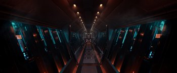 Movie still from “65” (2023), directed by Bryan Woods – A long hallway that has a lot of lights on it; Extreme Wide shot, High angle