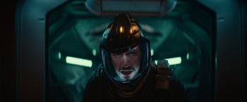 Movie still from “65” (2023), directed by Bryan Woods – A person wearing a helmet; Close Up shot, Overhead angle