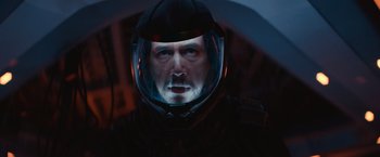 Movie still from “65” (2023), directed by Bryan Woods – A person wearing a space helmet; Close Up shot, Overhead angle