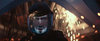 Movie still from “65” (2023), directed by Bryan Woods – A person wearing a helmet; Close Up shot, Overhead angle