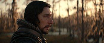 Movie still from “65” (2023), directed by Bryan Woods – A person wearing a jacket; Close Up shot, Low angle