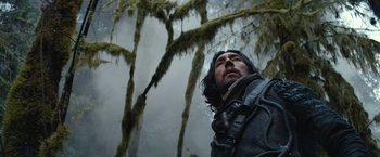 Movie still from “65” (2023), directed by Bryan Woods – A man with a beard is standing in the woods; Close Up shot, Low angle